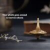 The Celestial Dragon brass fidget spinner in mid-spin, showing a hypnotic blur of the dragon carvings and its perfect balance.