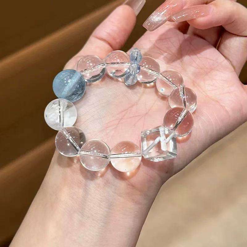 A woman wearing the Cancer Zodiac crystal energy bracelet, showing how it looks on the wrist.
