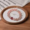 A close-up detail shot of the Rose quartz crystal bead on the Libra Zodiac.