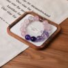 A close-up detail shot of the Amethyst quartz crystal bead on the Scorpio Zodiac.