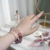 A woman wearing the Scorpio Zodiac crystal energy bracelet, showing how it looks on the wrist.