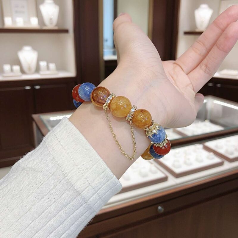 A woman wearing the Chinese Dragon Zodiac crystal energy bracelet, showing how it looks on the wrist.