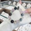 A woman wearing the Chinese Pig Zodiac crystal energy bracelet, showing how it looks on the wrist.