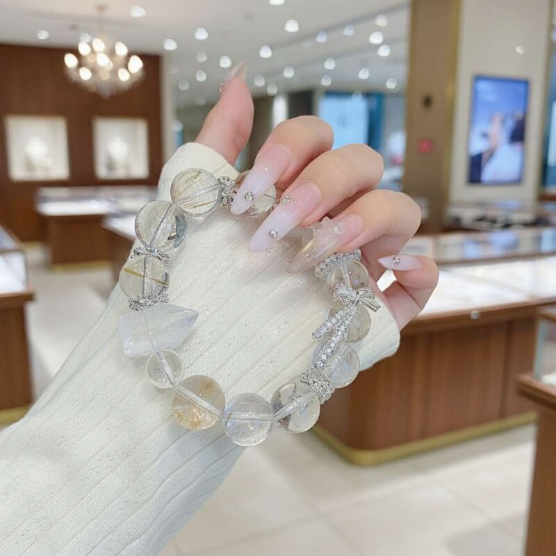 A woman wearing the Chinese Rabbit Zodiac crystal energy bracelet, showing how it looks on the wrist.