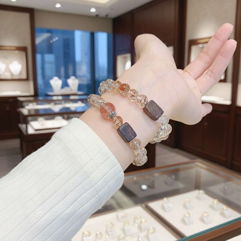 A woman wearing the Chinese Rooster Zodiac crystal energy bracelet, showing how it looks on the wrist.