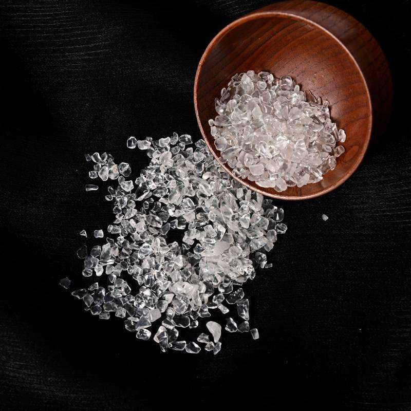 A close-up macro shot of the tumbled clear quartz demagnetizing stone, showing its clarity, natural facets, and sparkling texture.