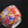 The imperial detailed Interlocking Lotus enameled handmade ceramic teacup, showcasing intricate pink and white lotus flowers.