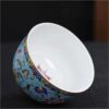 The imperial detailed Interlocking Lotus enameled handmade ceramic teacup, showcasing intricate pink and white lotus flowers.