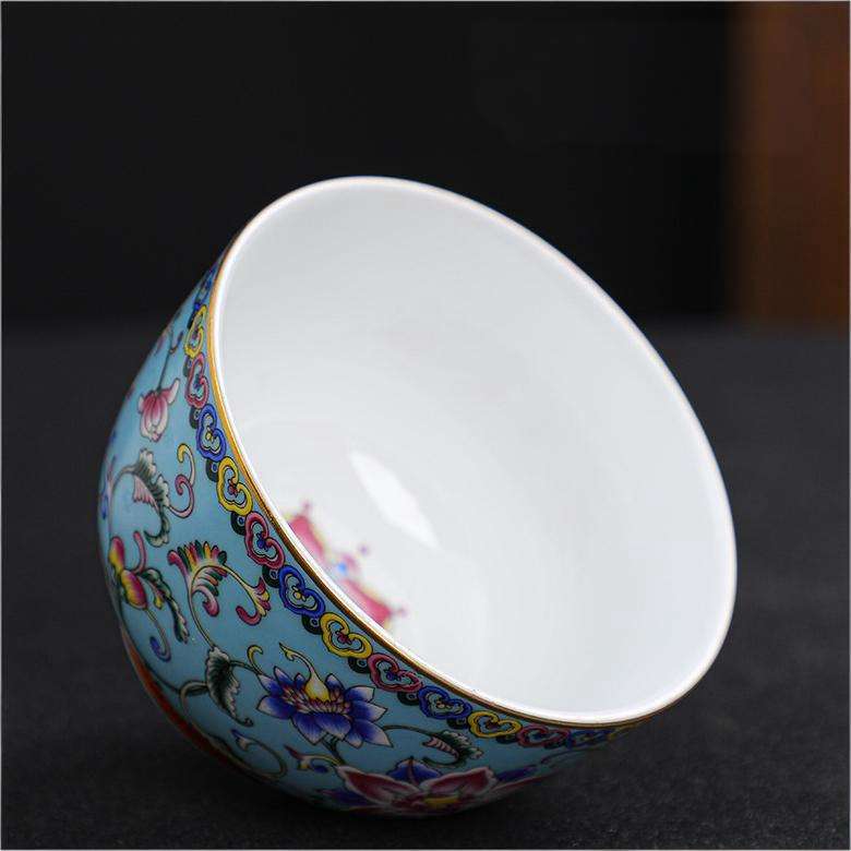 The imperial detailed Interlocking Lotus enameled handmade ceramic teacup, showcasing intricate pink and white lotus flowers.