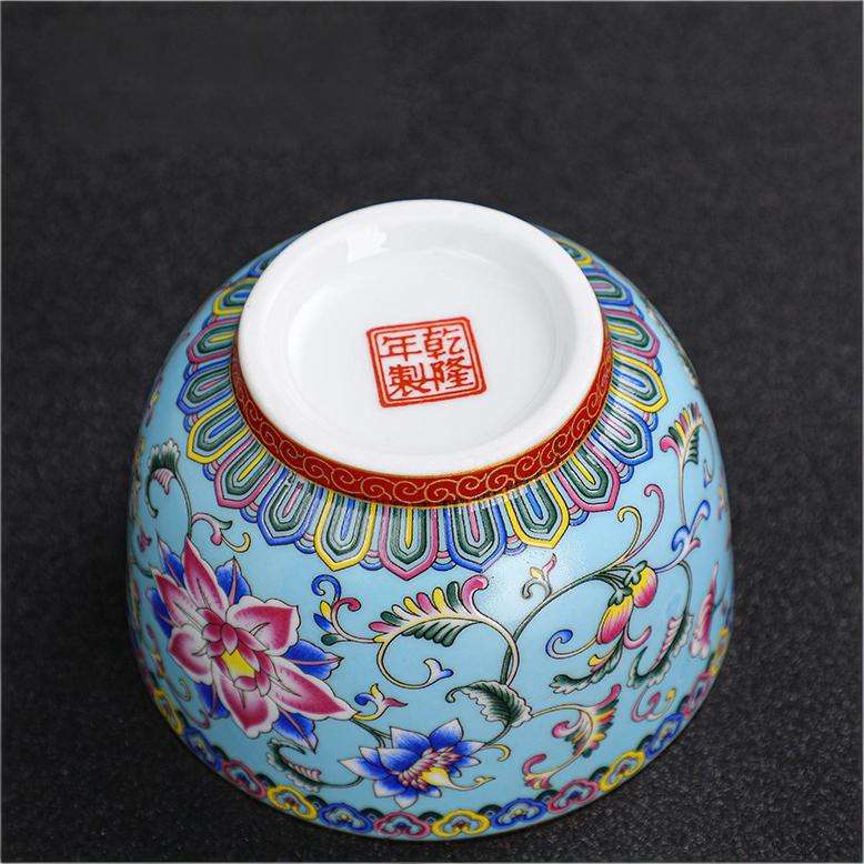 The imperial detailed Interlocking Lotus enameled handmade ceramic teacup, showcasing intricate pink and white lotus flowers.
