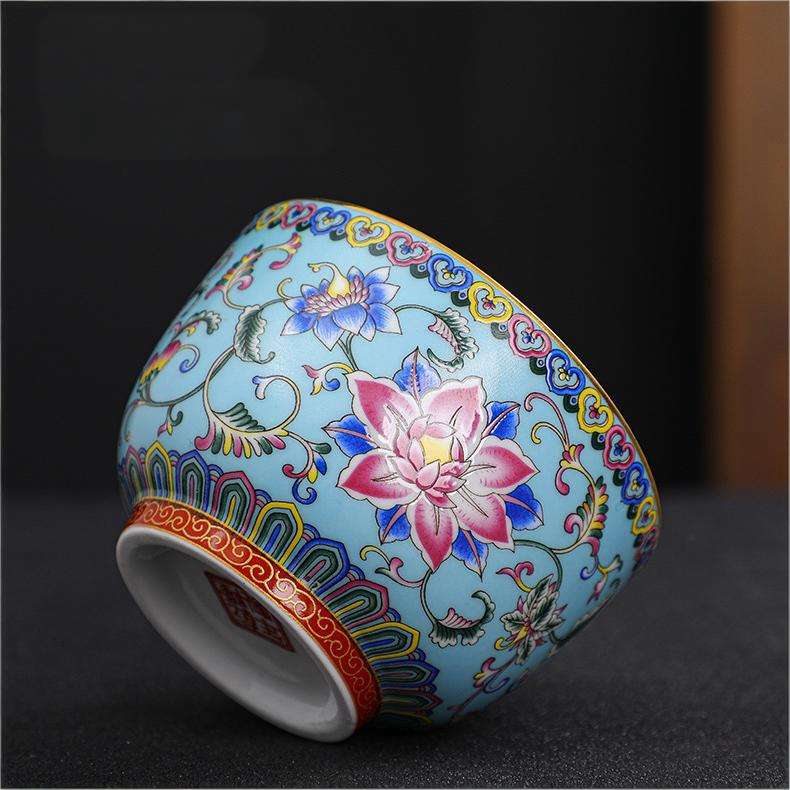 The imperial detailed Interlocking Lotus enameled handmade ceramic teacup, showcasing intricate pink and white lotus flowers.