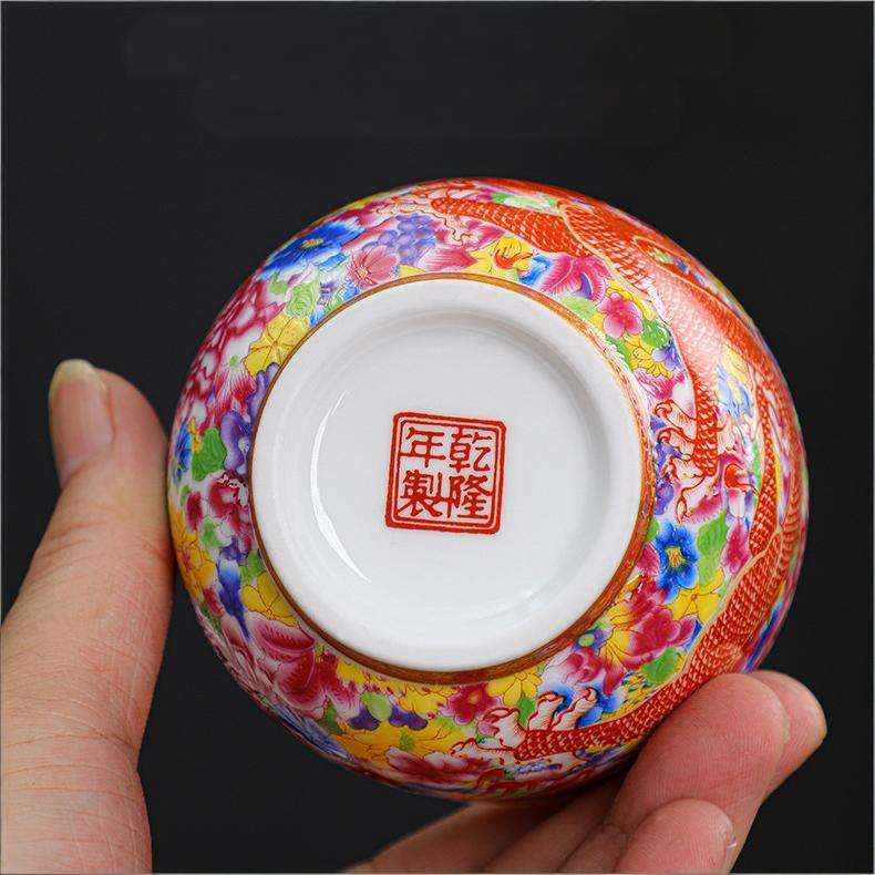 The imperial detailed Interlocking Lotus enameled handmade ceramic teacup, showcasing intricate pink and white lotus flowers.