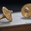 A close-up of the precision-engineered, durable tip of the brass fidget spinner, designed for a long and stable spin.