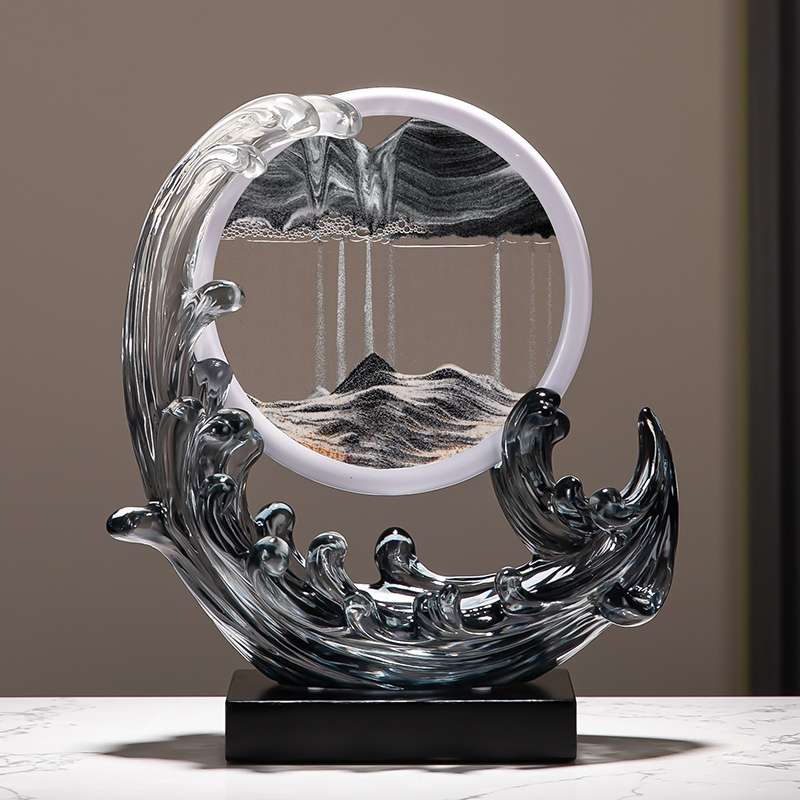 A Feng Shui Moving Sand Art Sandscape in black color on the desk.
