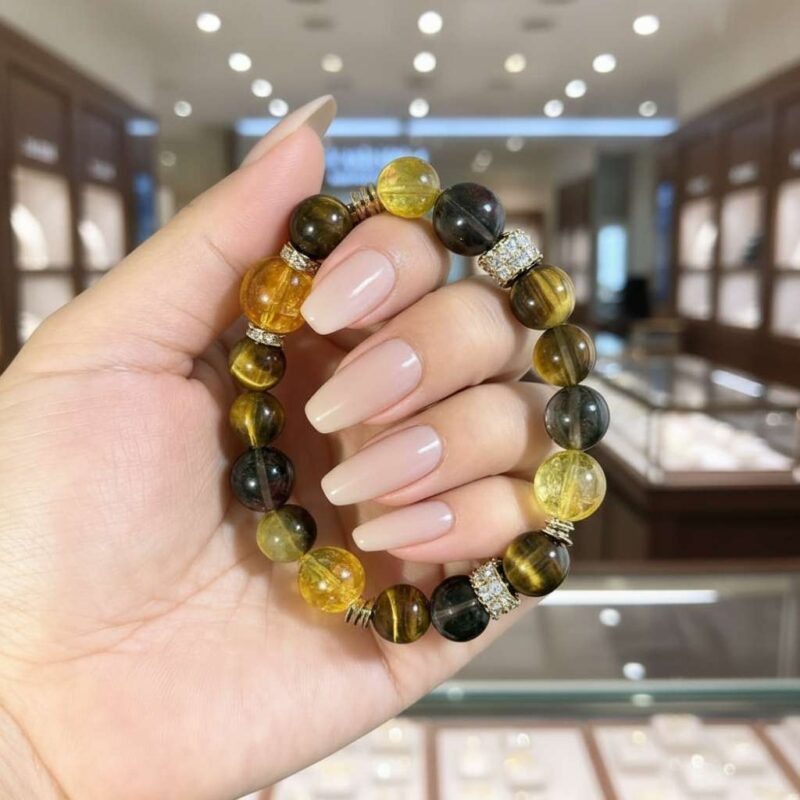 A woman wearing the Geng Metal crystal energy bracelet, showing how it looks on the wrist.