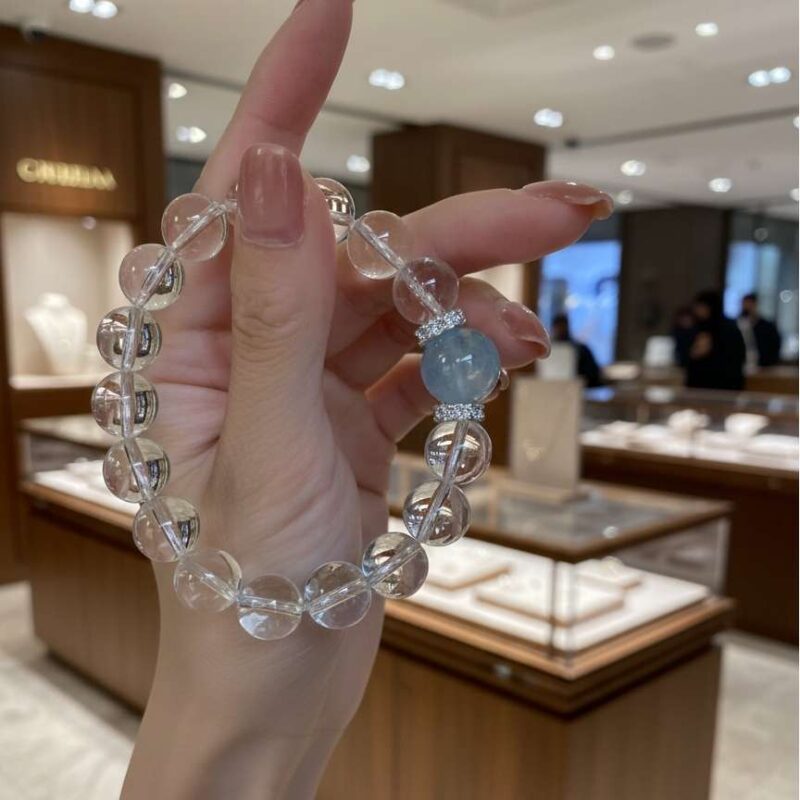 A woman wearing the Gui Water crystal energy bracelet, showing how it looks on the wrist.
