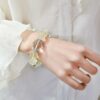 A woman wearing the Ji Earthd crystal energy bracelet, showing how it looks on the wrist.