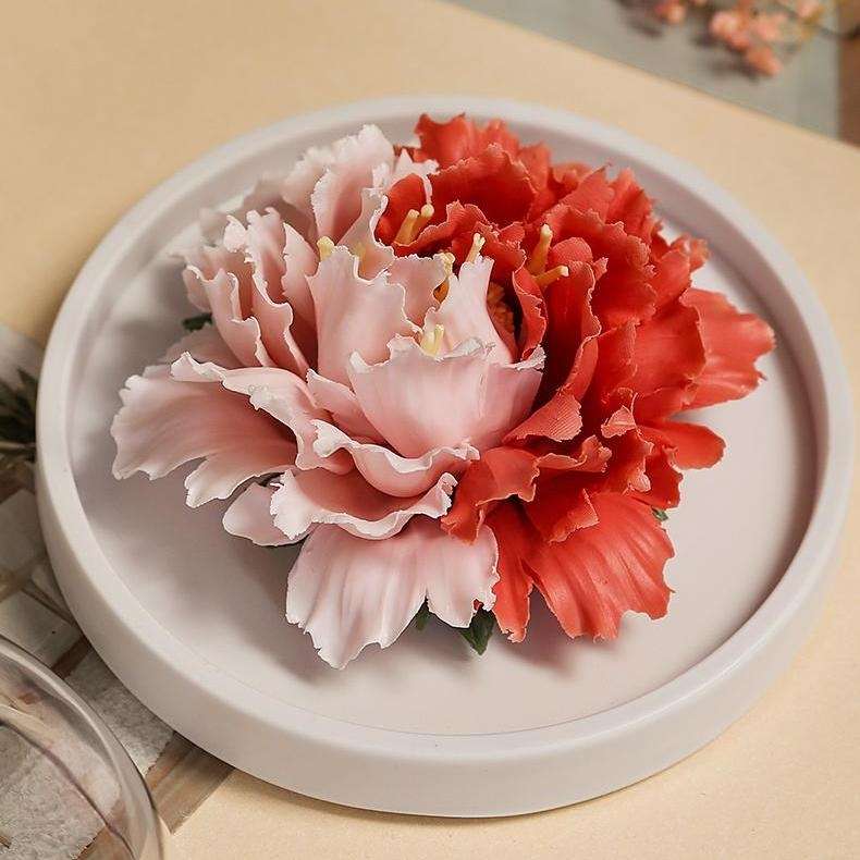 A close-up detail shot of the delicate, hand-sculpted petals on the porous porcelain peony flower aromatherapy diffuser.