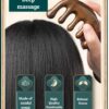 A person's hand holding the ergonomic sandalwood massage comb, showing its comfortable grip and the smooth, polished finish of the natural wood.