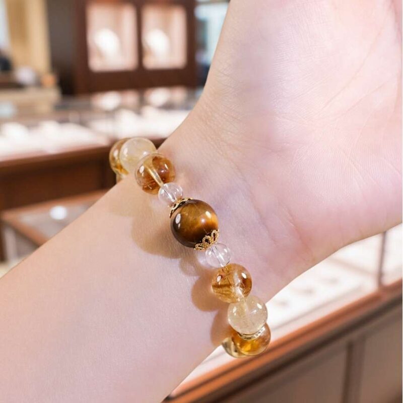 A woman wearing the Xin Metald crystal energy bracelet, showing how it looks on the wrist.