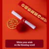 Close up of a red year of the horse ceramic ornament showing the golden coin detail, greeting scroll, and glossy porcelain finish for Lunar New Year decoration.