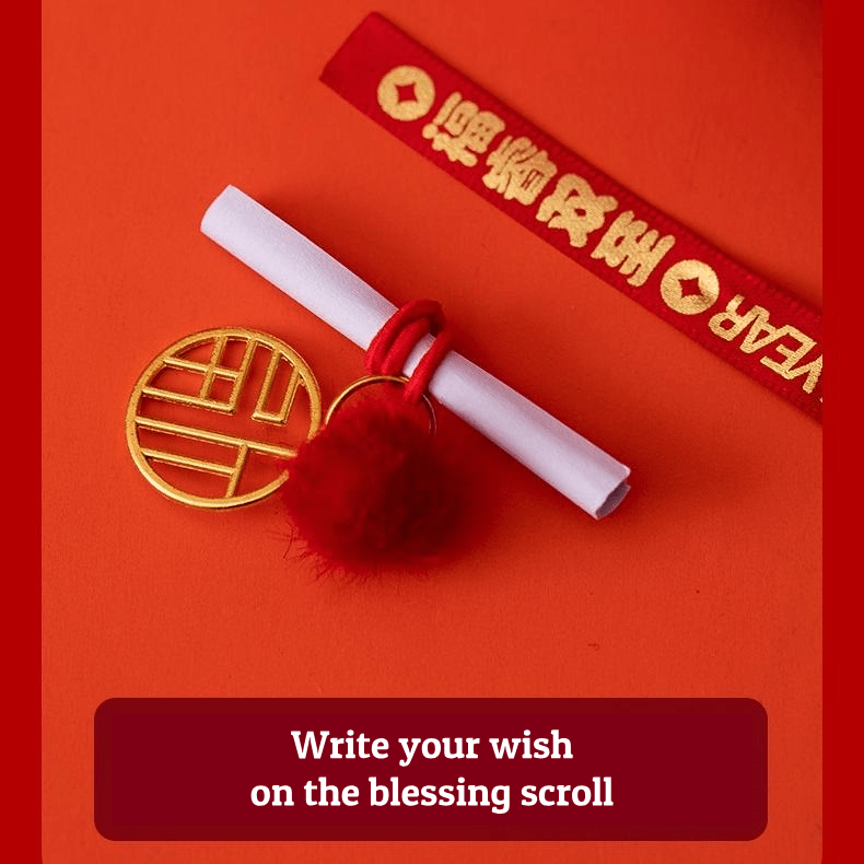 Close up of a red year of the horse ceramic ornament showing the golden coin detail, greeting scroll, and glossy porcelain finish for Lunar New Year decoration.