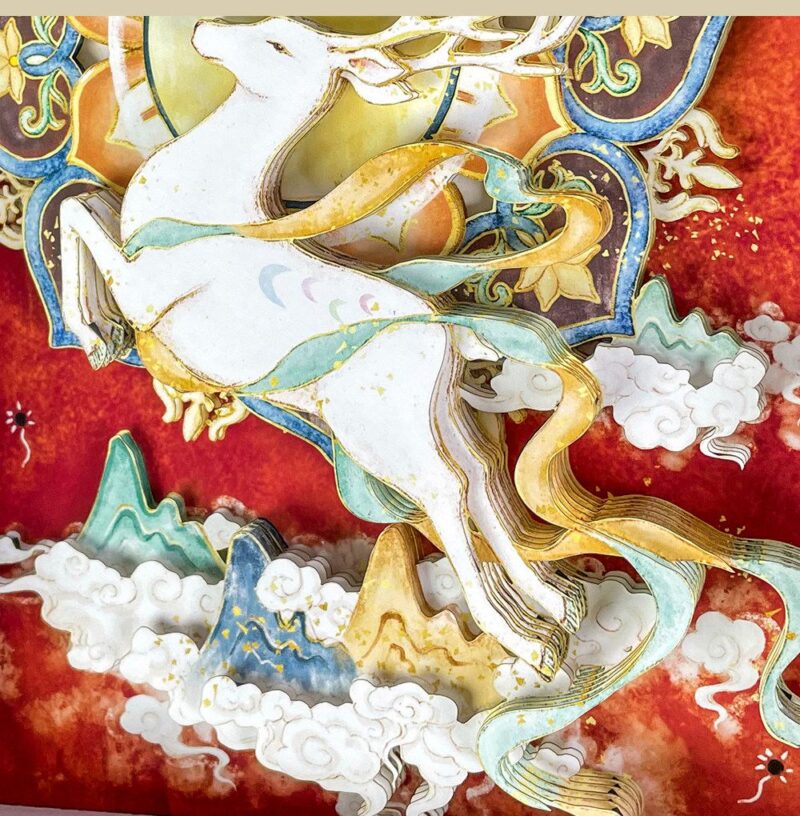 Close up of the Nine-Colored Deer 3D Chinese Paper Cutting showing the multi-layered paper craftsmanship and vibrant Dunhuang fresco colors.