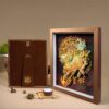 Red gift box with gold calligraphy next to the 3D Chinese Paper Cutting Qilin shadow box, perfect for Lunar New Year or corporate gifting.