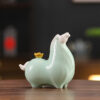 Close up detail of the golden cauliflower on the back of a cyan Chinese Ceramic Tang Horse Statue, symbolizing the pun for getting rich immediately.