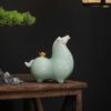 Close up detail of the golden cauliflower on the back of a cyan Chinese Ceramic Tang Horse Statue, symbolizing the pun for getting rich immediately.