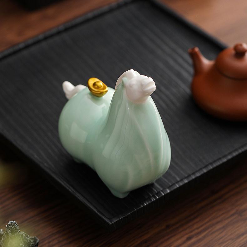 Close up detail of the golden cauliflower on the back of a cyan Chinese Ceramic Tang Horse Statue, symbolizing the pun for getting rich immediately.
