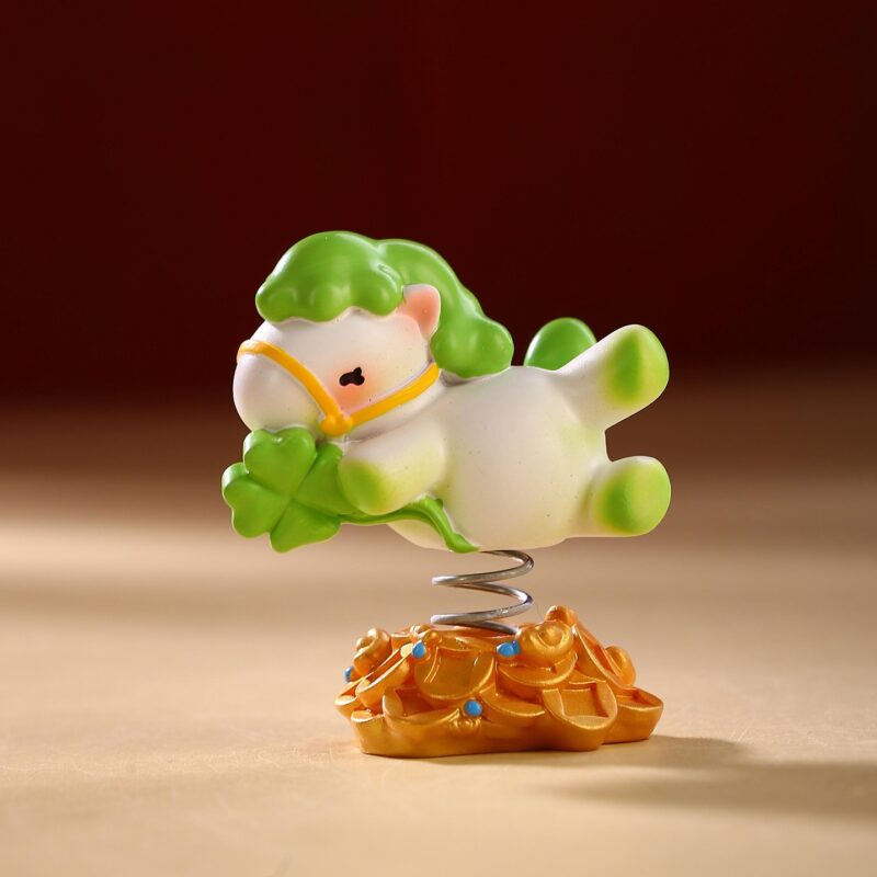 Close up of the Instant Wealth Year of the Horse Creative Spring Ornament with pink hair holding a gold ingot, mounted on a coin base with a spring.