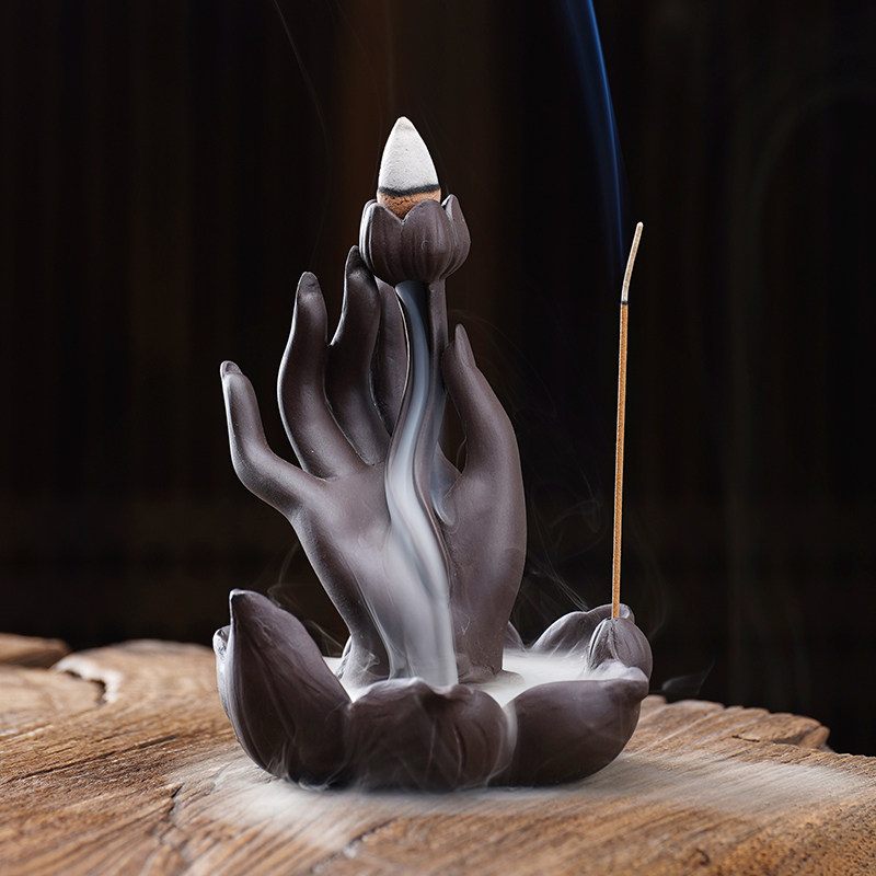 Purple clay Backflow Incense Burner Buddha Hand with a lotus flower design, sitting on a white background.