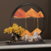 Elegant Feng Shui Moving Sand Art placed on a modern console table, showcasing the golden sand forming a mountain backing for the fortune deer statues.