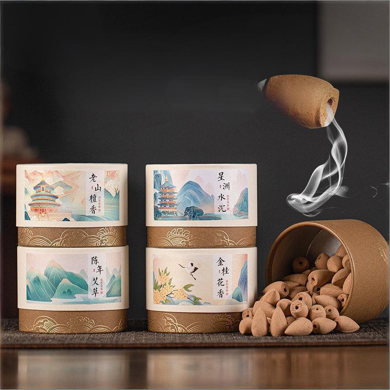 Packaging of Natural Waterfall Backflow Cones in various scents like Aged Mugwort and Sandalwood, displayed with a burning cone creating smoke.