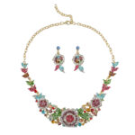 Sapphire blue Luxury Crystal Glass Party Jewelry Set featuring a blooming rose statement necklace and matching floral dangle earrings on a black display.